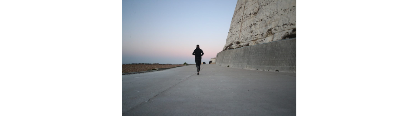 man running with sunrise