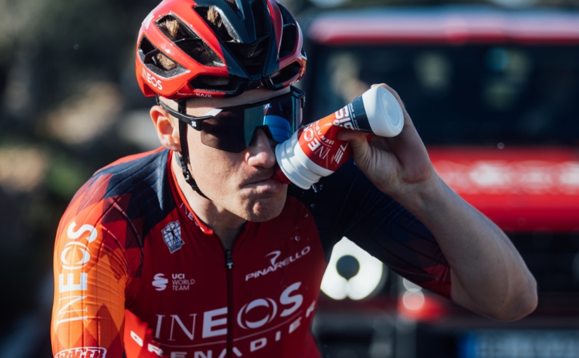 INEOS rider taking drink whilst on bike