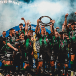 group of footballers celebrating with trophy