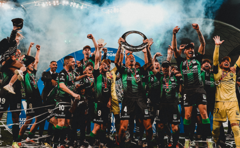 group of footballers celebrating with trophy