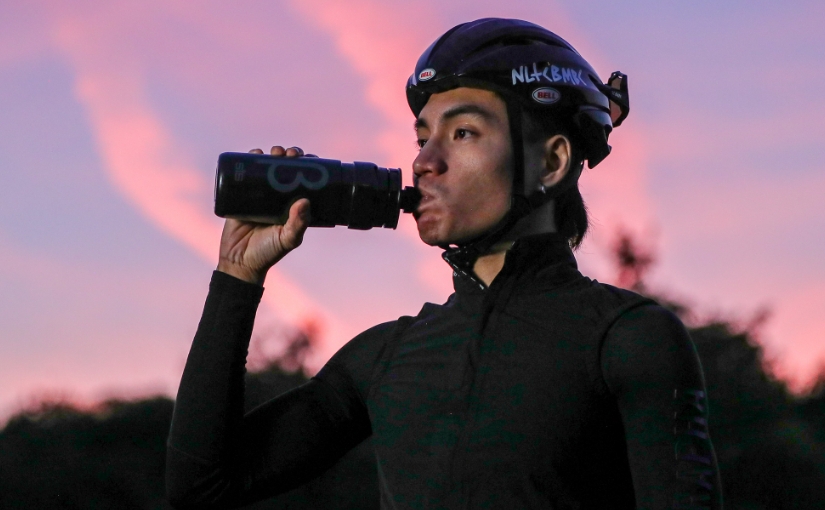 Radfahrer trinkt aus der Flasche