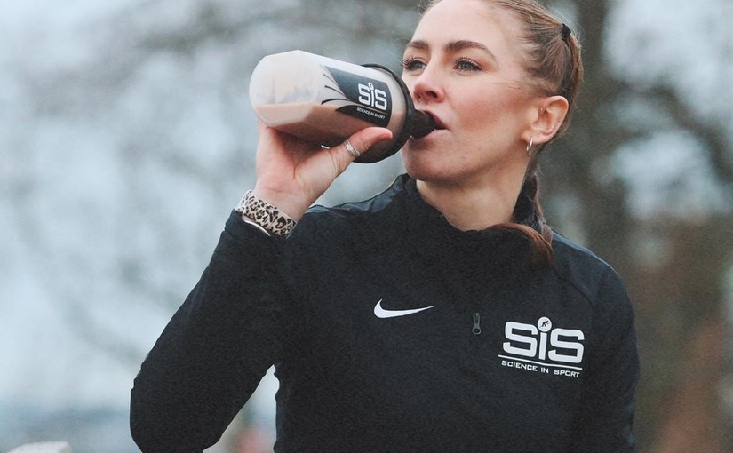 girl drinking shake out of bottle