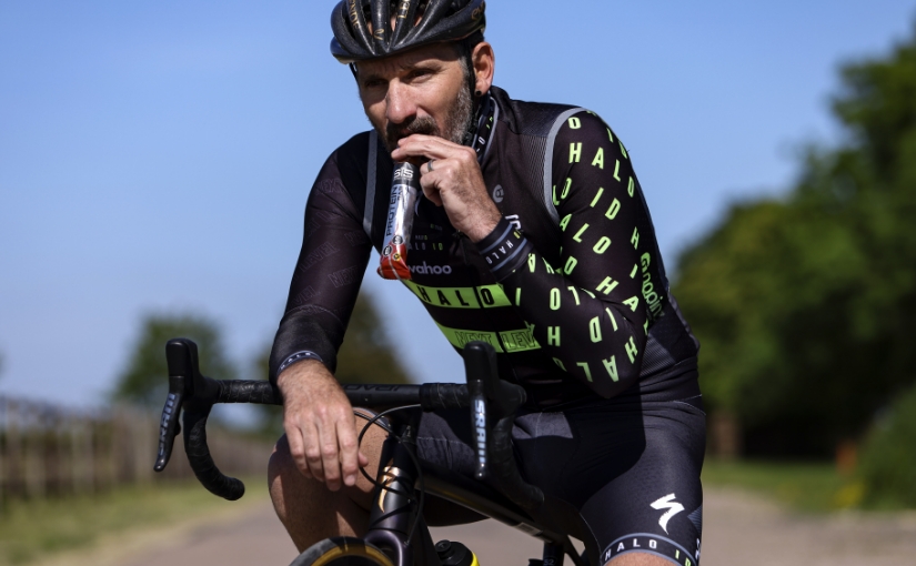 Tim Don eating protein bar on bike