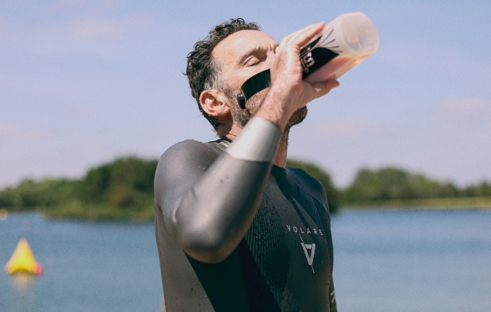Endurance swimmer consuming a creatine shake pre-race