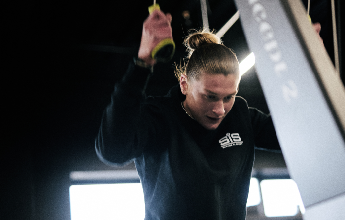Saskia Millard in the gym on a weight pulley 