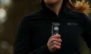Athlete holding a BETA Fuel Gel