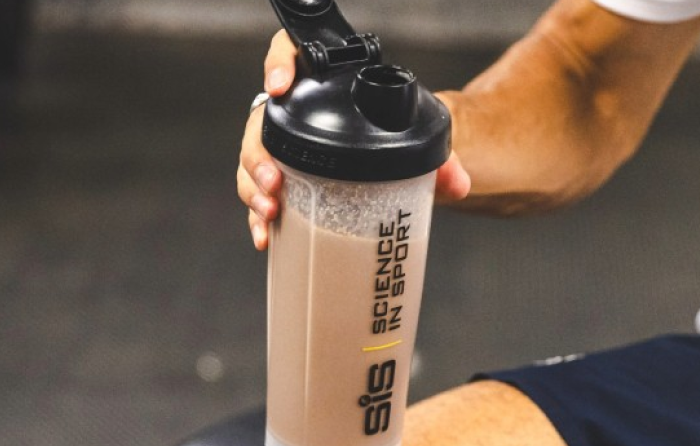Athlete drinking a SiS REGO Recovery Shake